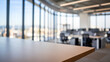 © Anuyj - Empty desk in modern office. Wooden table with blurred background of modern office space, ideal for product placement or business concept.