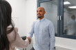 © 24K-Production - Excited African American job candidate entering the meeting office, warm shaking hands with an Indian female manager. Recruitment concept.