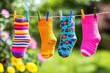 © PerfectPix - Colorful Socks Hanging on a Line A Bright and Cheerful Display of Unique Designs in Nature's Setting