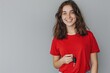 © Alla - A young woman holds a set of car keys while wearing a bright red shirt