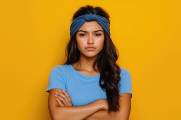 Wall Mural - Portrait of a woman wearing a blue shirt and matching headband, suitable for editorial or commercial use