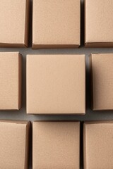 Poster - A close-up view of neatly arranged, plain cardboard boxes showcasing a minimalist design, perfect for storage or shipping concepts.