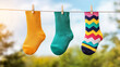 © ArtifyGraphy - Vibrant collection of colorful socks hanging on a clothesline against a bright outdoor background