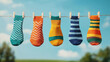 © ArtifyGraphy - Colorful socks hanging on a line a fun display of patterns and textures in bright sunshine