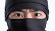 © Nikita - A close-up of a ninja’s eyes, intensely focused and peering through a black mask, symbolizing stealth, discipline, and martial arts..