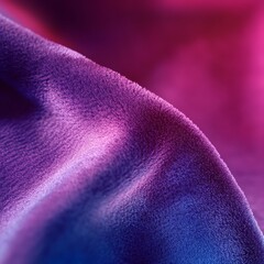 Close-up of pink and purple velvet fabric with smooth texture and gradient lighting.