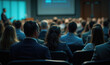 © Maestro - Business professionals attending a conference in a large auditorium.