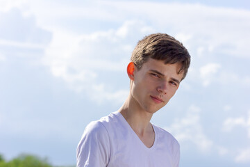 Wall Mural - A young man with brown hair and a white shirt