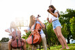 © peopleimages.com - Nature, playing and children with cello and violin for lesson, practice and learning with teacher. Morning, music and woman with kids with musical instruments for talent show, performance or recital