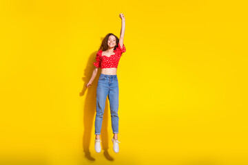 Wall Mural - Full size photo of pretty young girl hang flying empty space wear trendy red outfit isolated on yellow color background