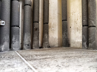 Pipes insulated along a wall in a residential building, highlighting maintenance and infrastructure in a domestic space