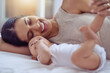 © peopleimages.com - Mom, baby and bonding on bed in home for affection, playing and support with growth or wellness. Love, newborn or happy woman in nursery together with security, protection or morning routine for care