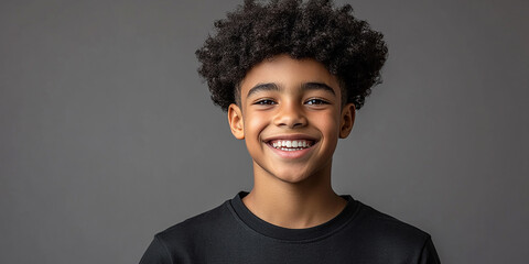 Black teenager boy on a studio background