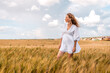 © Константин Плотников - Russia, Republic of Tatarstan, Kalmash village, August 01, 2024, 17:00, girl in a dress in a wheat field in summer