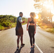 © Delmaine Donson/peopleimages.com - Happy couple, back and fitness with road in nature for workout, running or exercise together. Young, man and woman with sportswear for cardio, practice or outdoor training on asphalt, street or path