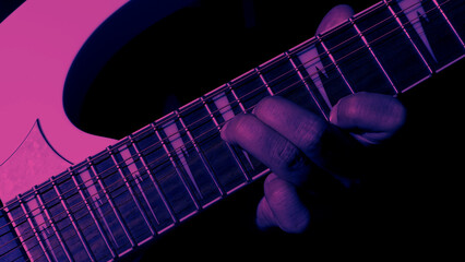 Guitarist Playing Guitar In Studio. Low key of man hand play white electric guitar for songs and cover music or skill practice. Close up of musician playing guitars instrument against black background