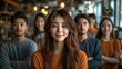 © Vesna - a vibrant group of young asian creative professionals confidently posing together in a modern workspace emphasizing teamwork diversity and innovation in a startup environment
