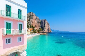 Scenic coastal view with colorful buildings and clear turquoise waters.