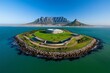 © Thanyarat - Robben Island off the coast of Cape Town, with its historic prison buildings and the distant outline of Table Mountain on the horizon
