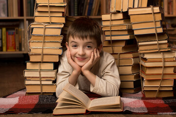 Smiling boy lying on the floor surrounded by books, enjoying a moment of reading. Perfect for educational, reading promotion, and childhood curiosity themes