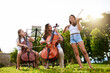 © peopleimages.com - Park, children and woman with violin and cello for playing, practice and music lesson with teacher. Morning, nature and person with kids and string instrument for talent show, rehearsal or recital