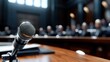 © Pinklife - A close-up shot of a single microphone placed on a wooden conference table, with a blurred audience in the background, emphasizing the atmosphere of a public address.