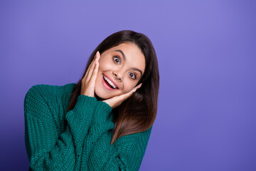 Portrait of nice young girl hands touch cheeks empty space wear sweater isolated on violet color background