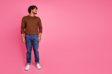 Photo of cheerful nice man wear stylish brown clothes look empty space isolated on pink color background