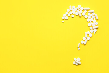 Wall Mural - Question mark made of white pills on yellow background