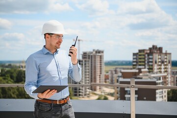 Engineer with tablet, building inspection. Construction man in helmet build new house