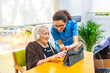 © unai - Senior woman and nurse using digital tablet in the geriatrics