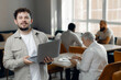 © Parilov - Caucasian Entrepreneur in Modern Office Environment