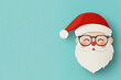 © AIPhoto - Cheerful Santa Claus with glasses and red hat, smiling against light blue background, embodies festive spirit of Christmas