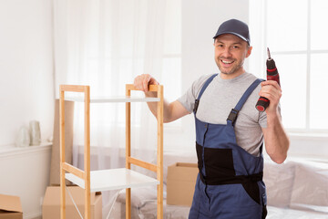 Fototapete - Furniture Assembly. Handyman Worker Posing Installing Cabinet Holding Electric Drill Standing Posing Indoors. Free Space