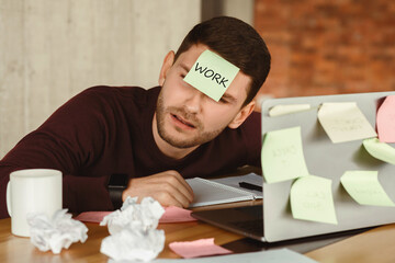 Poster - Overworked man having a nap sleeping at laptop with sticky notes everywhere, tired of office multitasking work indoor. Selective Focus