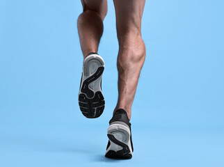 Wall Mural - Man running on light blue background, closeup