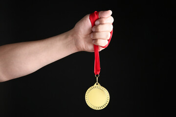 Poster - Man with golden medal on black background, closeup