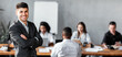 © Prostock-studio - Successful Business People. Businessman At Corporate Meeting With Coworkers Smiling To Camera Standing In Modern Office. Empty Space