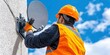 © Brian - a worker installing a tv satellite dish on a house