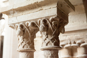 Wall Mural - Closeup of details of decorative capitals of columns of cloister in Monastery of Santa Maria de Vallbona, Urgell, Catalonia, Spain..