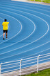 © Nicolas Ospina - Unrecognizable man on olympic track with copy space