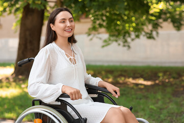 Canvas Print - Portrait of young woman in wheelchair enjoying sunny days outdoors