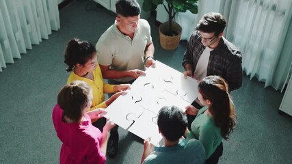 Sticker - Top view of smart business people put last piece of jigsaw puzzle together to complete puzzle and standing while wearing casual cloth. Group of diverse team finding solution with teamwork. Symposium.