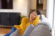 © Wavebreak Media - asian senior woman relaxing on couch at home, reflecting during quiet afternoon