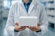 © top images - A doctor is holding a white box in a pharmacy
