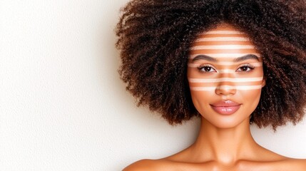 Portrait of a beautiful young woman with a bold makeup design on her face.