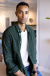 © Wavebreak Media - Confident african american man in green shirt sitting at home, looking at camera