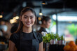 © mertingen - Female waitress smiling in restaurant