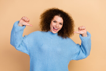 Sticker - Photo of young positive funny successful girl in blue knitted sweater pointing fingers at herself so proud isolated on beige color background