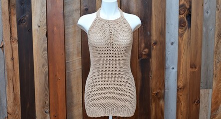 Beige crochet knit sundress with halter neckline and open back display on aesthethic wood wall background